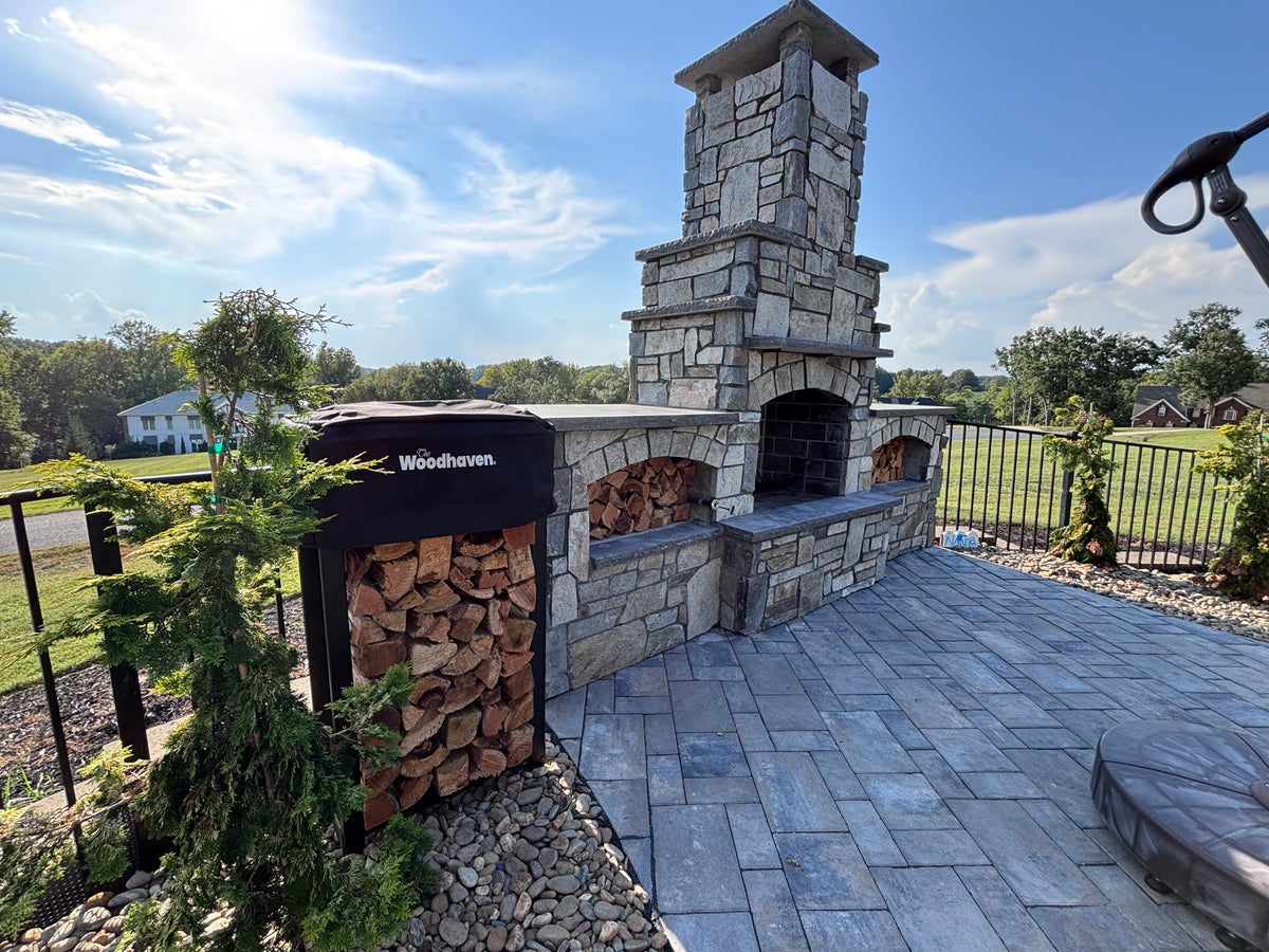 A rack beside an outdoor chimney on a paver patio